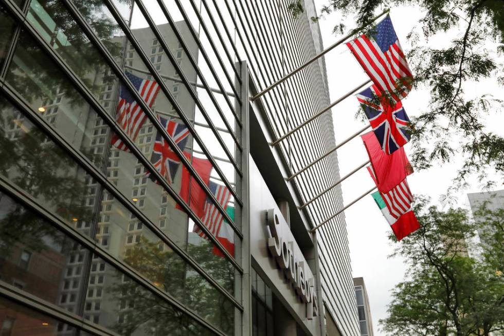 Flags fly on the front of Sotheby's auction house, in New York, Monday, June 17, 2019. BidFair ...