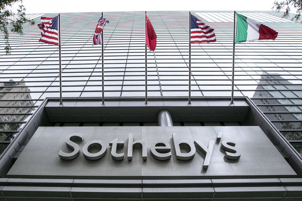 Flags fly on the front of Sotheby's auction house, in New York, Monday, June 17, 2019. BidFair ...