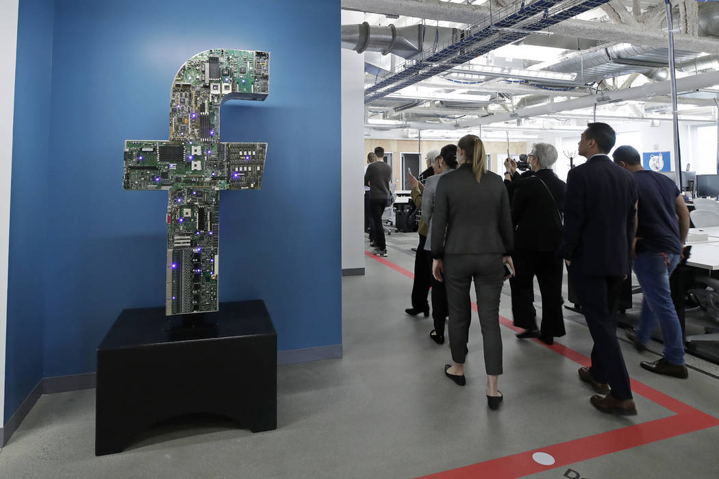 FILE - In this Jan. 9, 2019, file photo, media and guests tour Facebook's new 130,000-square-fo ...