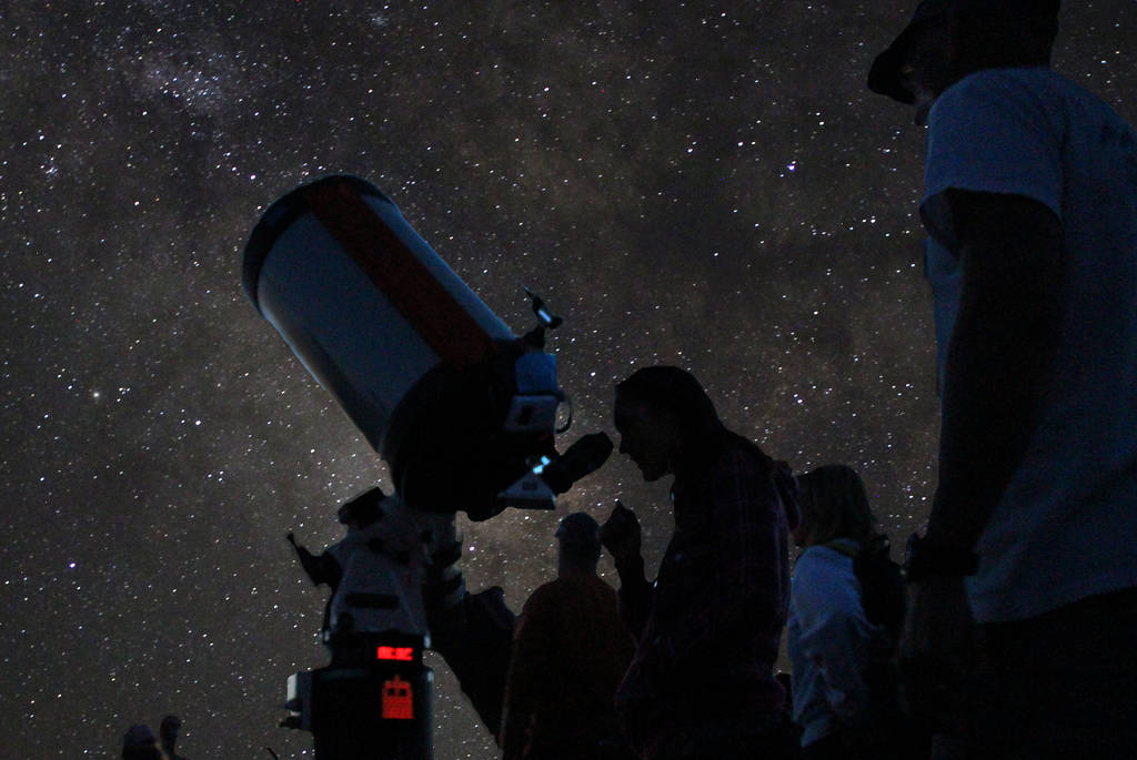 An amateur astronomer looks through a telescope at Grand Canyon National Park during the annu ...