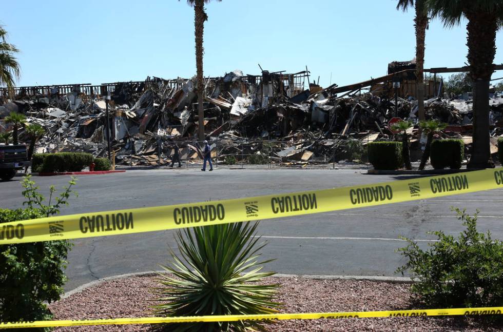 The rubble of burned-out office building at The Park at 3900 Paradise Road is blocked by cautio ...