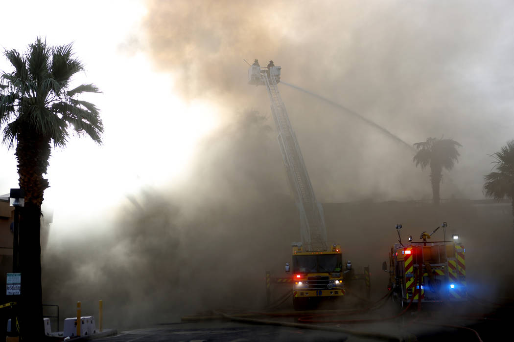 Firefighters work to gain control of a fire at a business complex near Paradise Road and East T ...