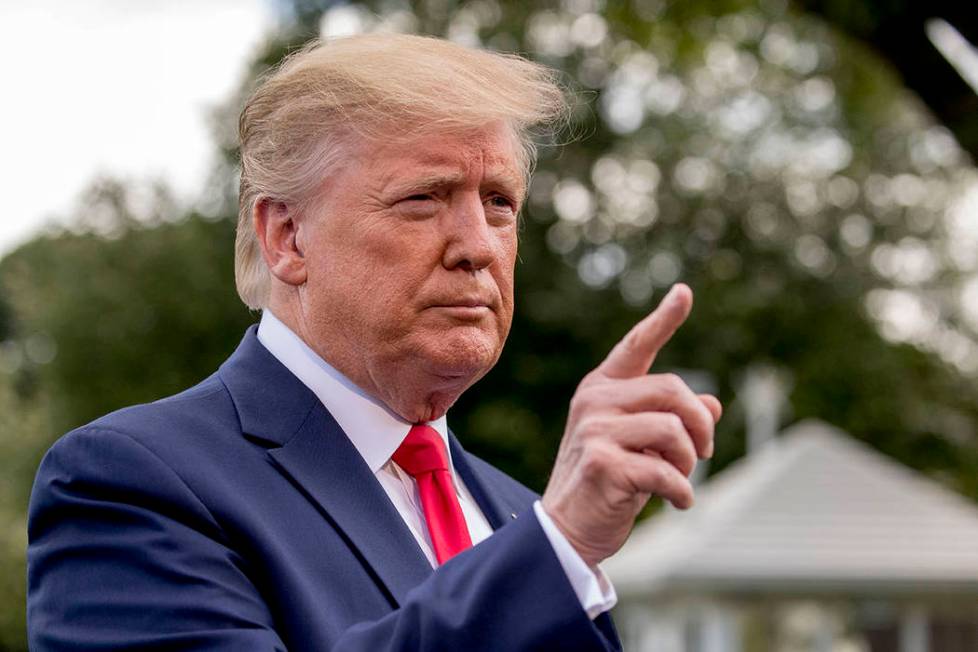 President Donald Trump calls on a reporter before boarding Marine One on the South Lawn of the ...