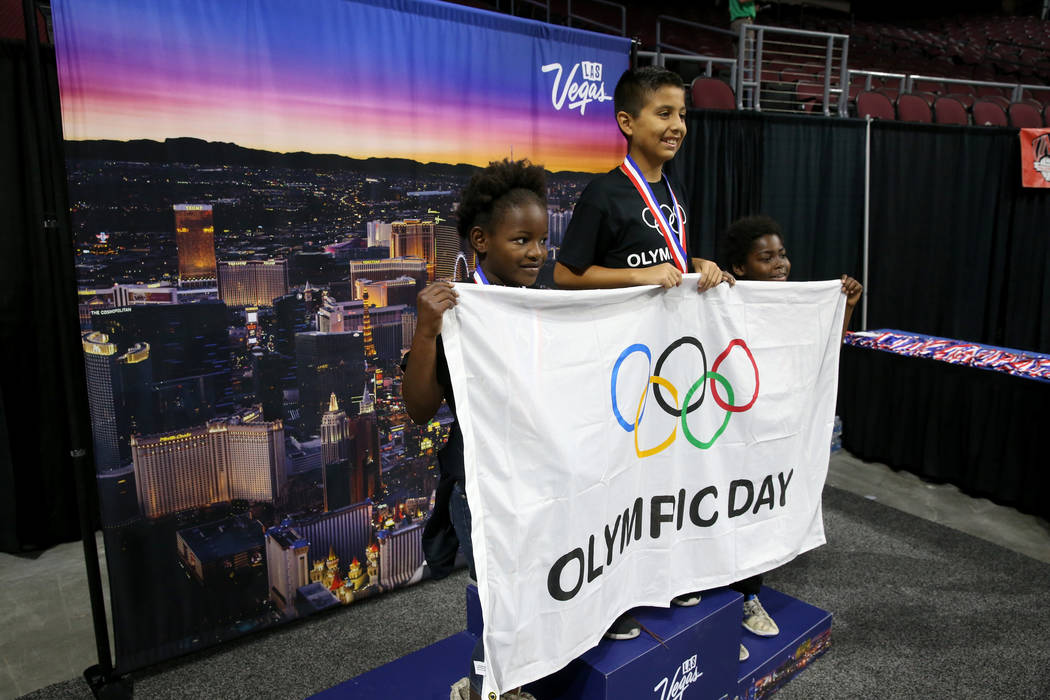 Semajanae Griffin, 9, from left, Luis Delgadillo, 11, and Kemaj Griffin 9, pose on the podium o ...