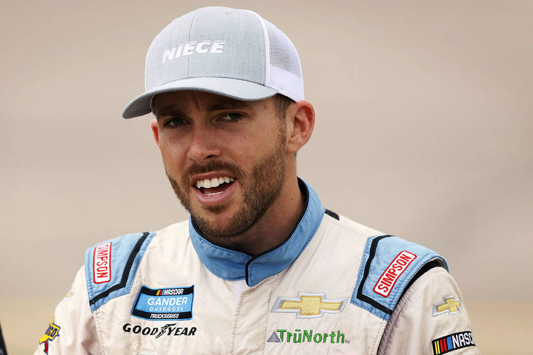 Ross Chastain walks to his truck before the start of the NASCAR Truck Series auto race, Sunday, ...