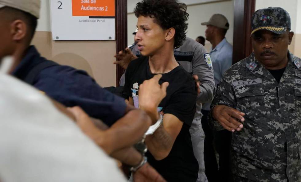 In this June 13, 2019 file photo Rolfy Ferreyra Cruz, center, is taken to court by police in Sa ...