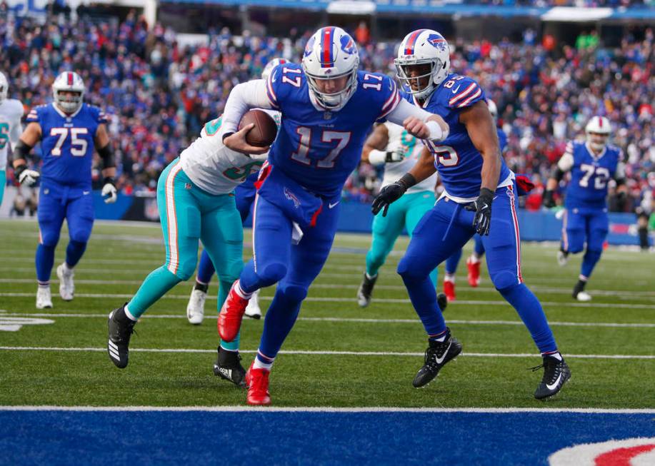 Buffalo Bills quarterback Josh Allen (17) scores a touchdown during the second half of an NFL f ...