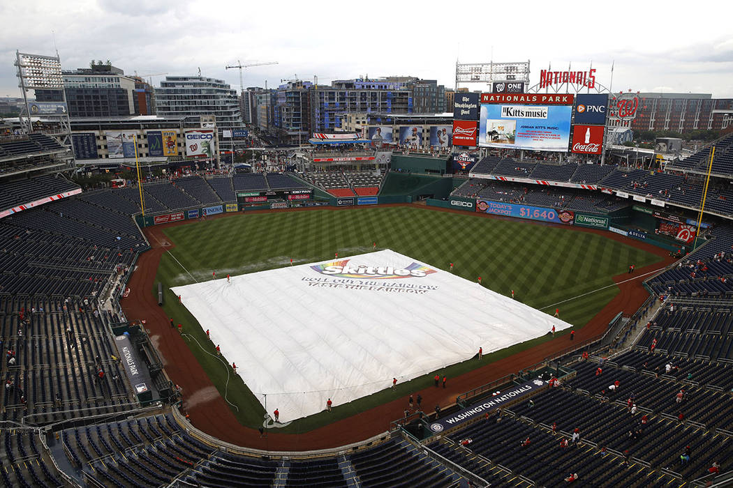 A tarp covers the infield during a rain delay before a baseball game between the Philadelphia P ...