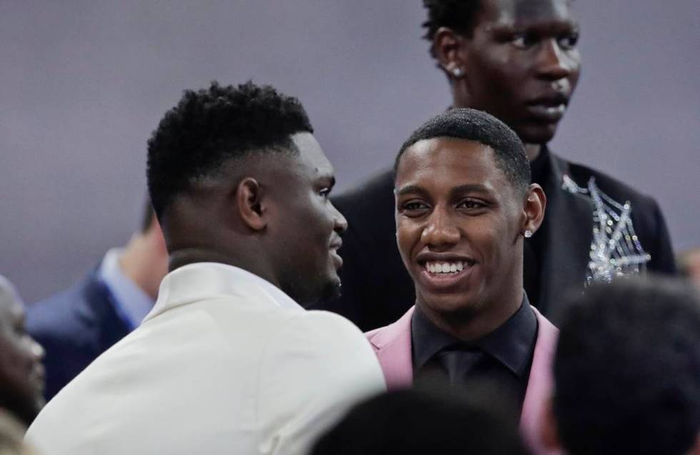 Duke's RJ Barrett, center, talks to Zion Williamson, as Oregon's Bol Bol, back, looks elsewhere ...