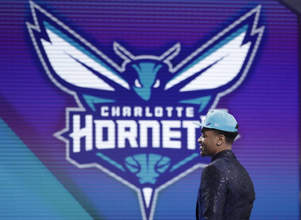 Kentucky's P.J. Washington walks on stage after the Charlotte Hornets selected him as the 12th ...