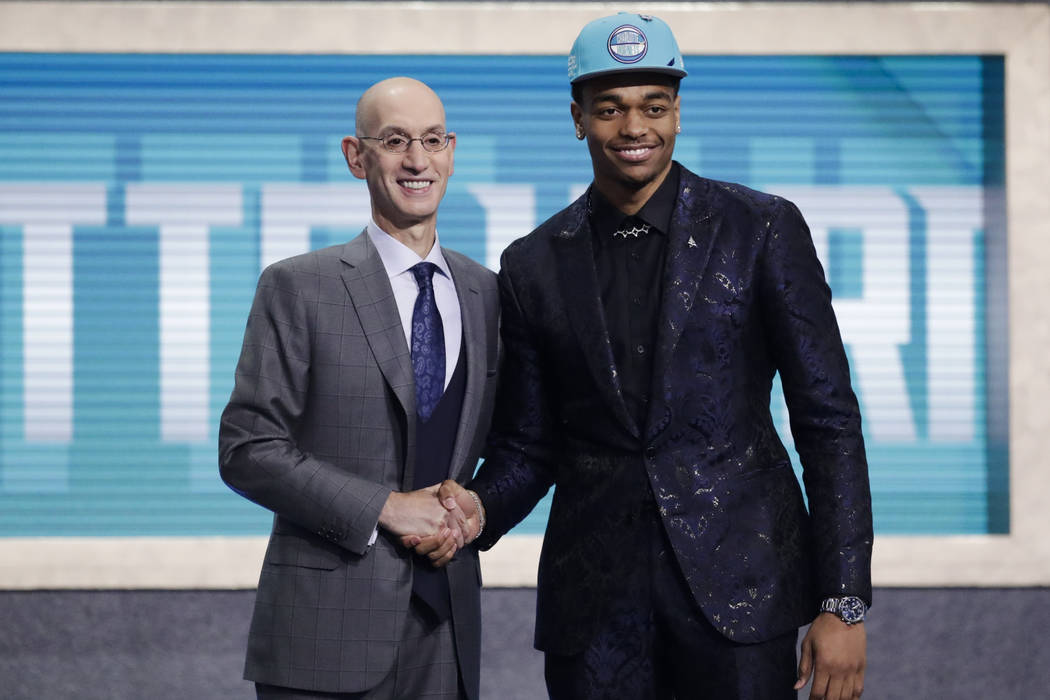 NBA Commissioner Adam Silver, left, poses for photographs with Kentucky's P.J. Washington, aft ...