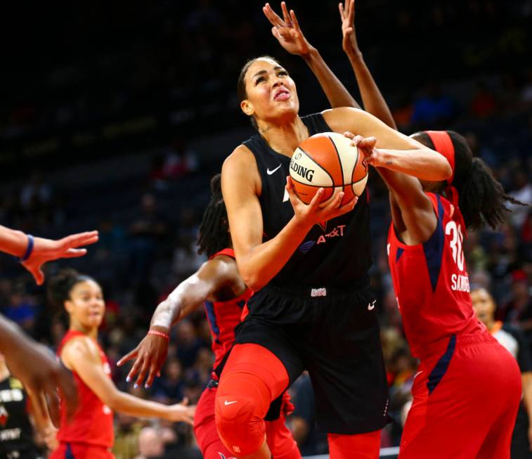 Las Vegas Aces center Liz Cambage (8) drives past Washington Mystics forward LaToya Sanders (30 ...