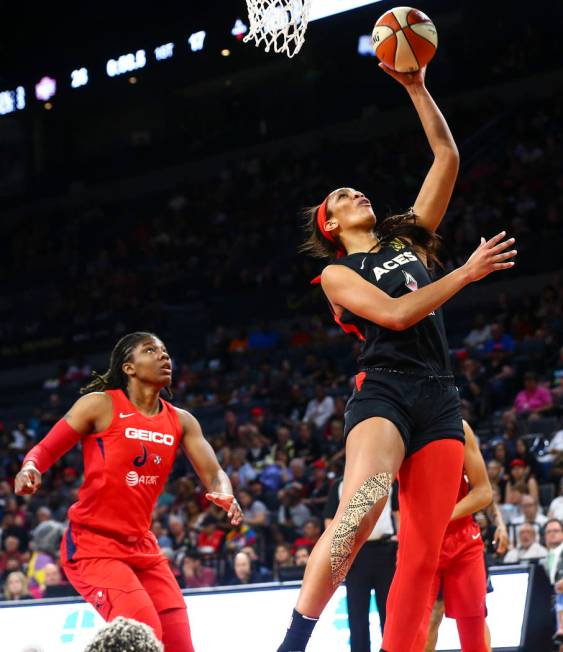 Las Vegas Aces center A'ja Wilson (22) goes to the basket past a Washington Mystics player duri ...