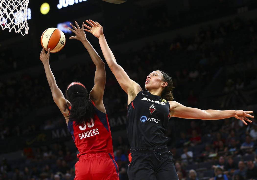 Washington Mystics forward LaToya Sanders (30) blocks a shot from Las Vegas Aces forward Dearic ...