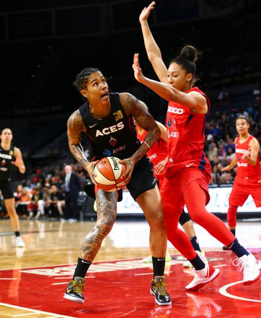 Las Vegas Aces forward Tamera Young (1) looks to shoot around Washington Mystics forward Aerial ...