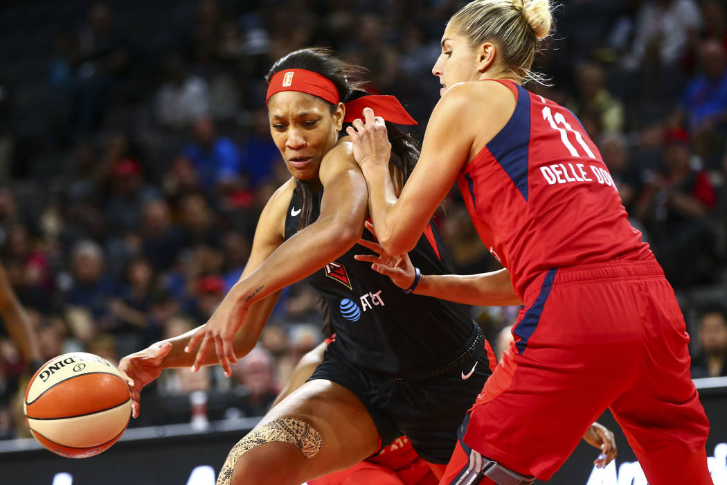 Las Vegas Aces center A'ja Wilson (22) moves the ball around Washington Mystics forward Elena D ...