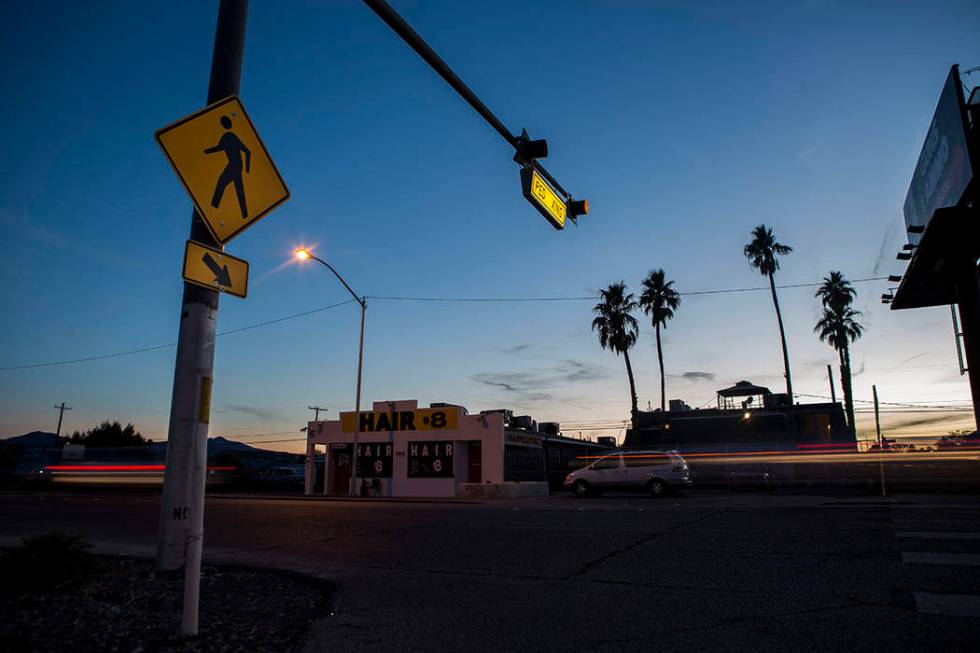 Cars drive by a crosswalk at the intersection of Whitney Avenue and Boulder Highway in Las Vega ...