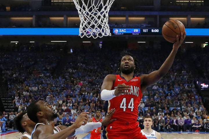 In this April 7, 2019 photo, New Orleans Pelicans forward Solomon Hill, right, goes to the bask ...