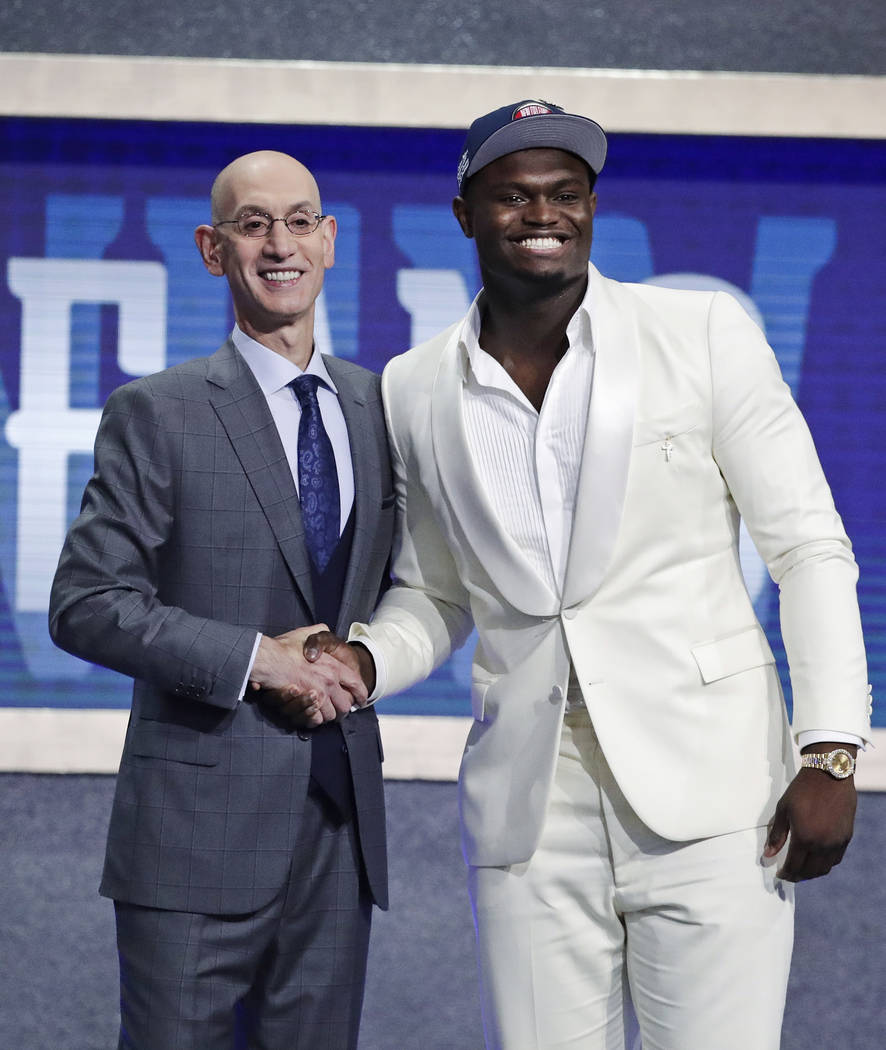 DUke's Zion Williamson, right, poses for photographs with NBA Commissioner Adam Silver after be ...