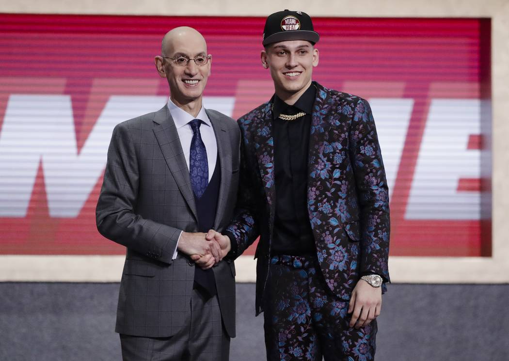 NBA Commissioner Adam Silver, left, poses for photographs with Kentucky's Tyler Herro after the ...
