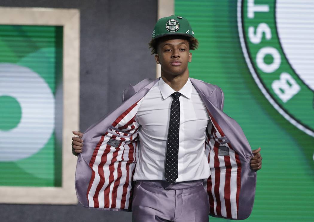 Indiana's Romeo Langford shows off his jacket lining, with Indiana colors, after the Boston Cel ...