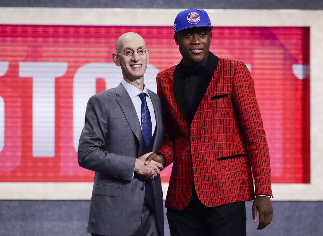 NBA Commissioner Adam Silver, left, poses for photographs with Sekou Doumbouya, of France, afte ...