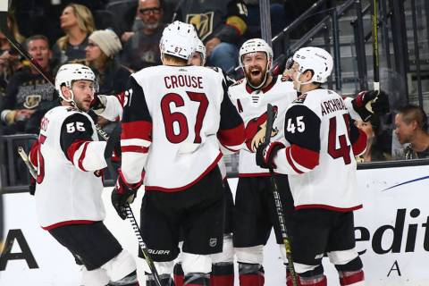 Arizona Coyotes players celebrate their third goal against the Golden Knights during the second ...