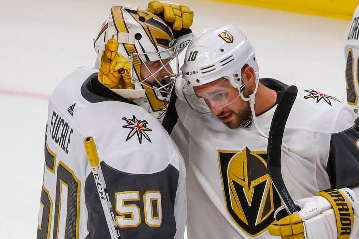 Vegas Golden Knights goaltender Zach Fucale (50) smiles as Brooks Macek (10) congratulates him ...