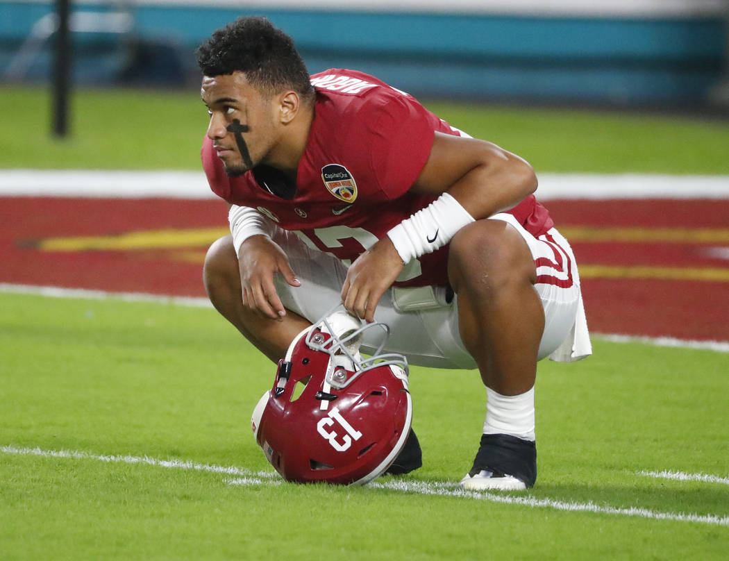 Alabama quarterback Tua Tagovailoa (13) warms up before the Orange Bowl NCAA college football g ...