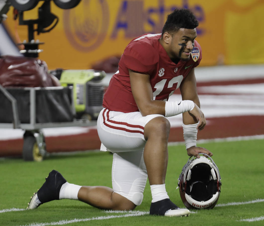 Alabama quarterback Tua Tagovailoa (13) warms up before the Orange Bowl NCAA college football g ...