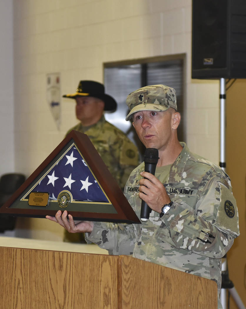 Nevada Army Guard chaplain Capt. Troy Dandrea holds the flag that will be permanently displayed ...