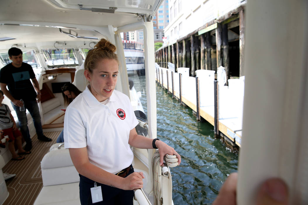 Crew member Katelyn Stimpson prepares to tie a luxury harbor shuttle from Encore Boston Harbor ...