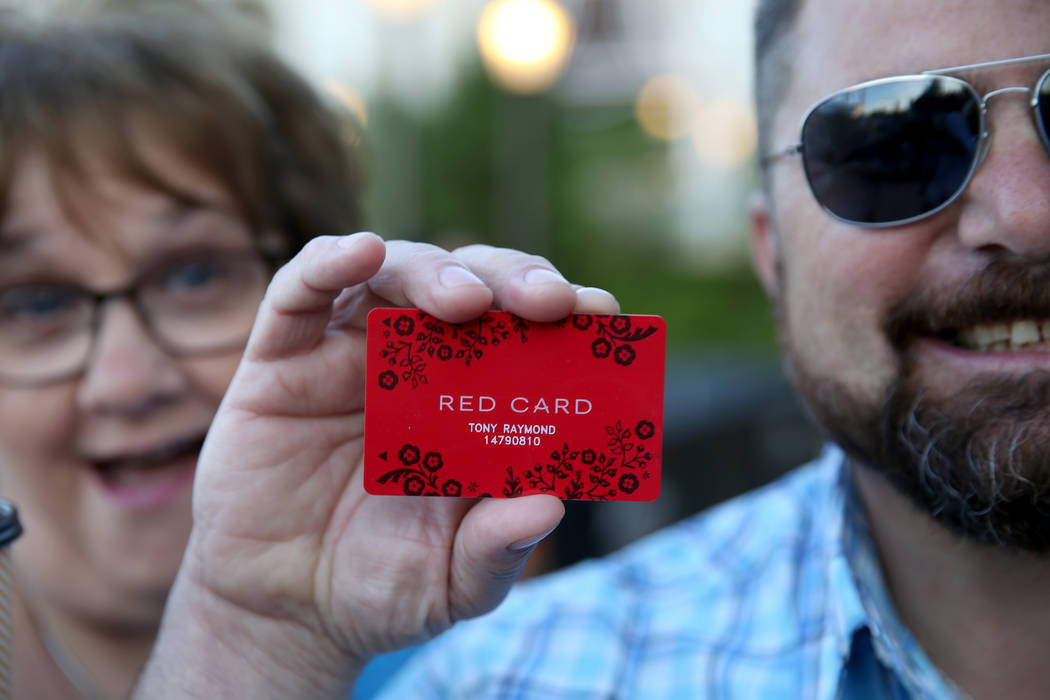 Tony Raymond, of Everett, Mass., shows his newly-acquired Red Card with Debbie Capozzi, of Wilm ...