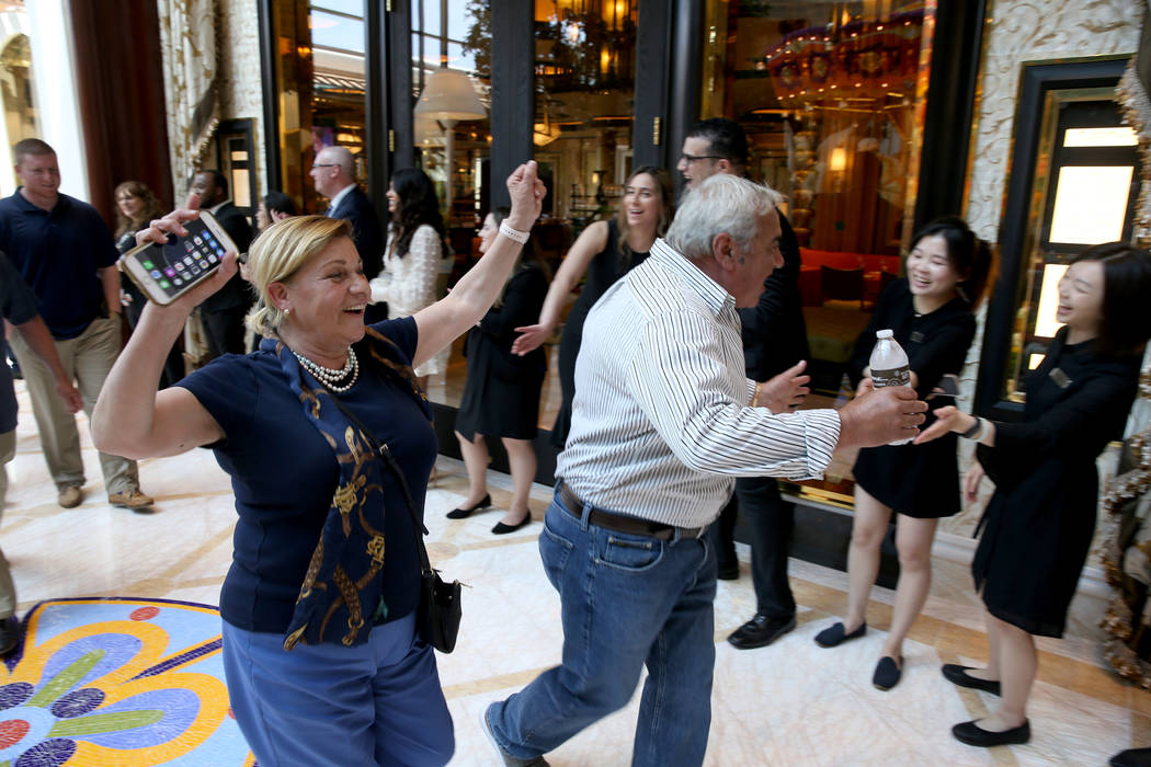 Employees cheer as Cristina and Tony Digiancomo, of Saugus, Mass., arrive in the Garden Lobby d ...