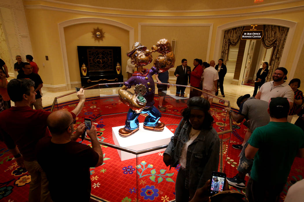 Guests check out Jeff Koons' Popeye statue on opening day of the $2.6 billion Encore Boston Har ...