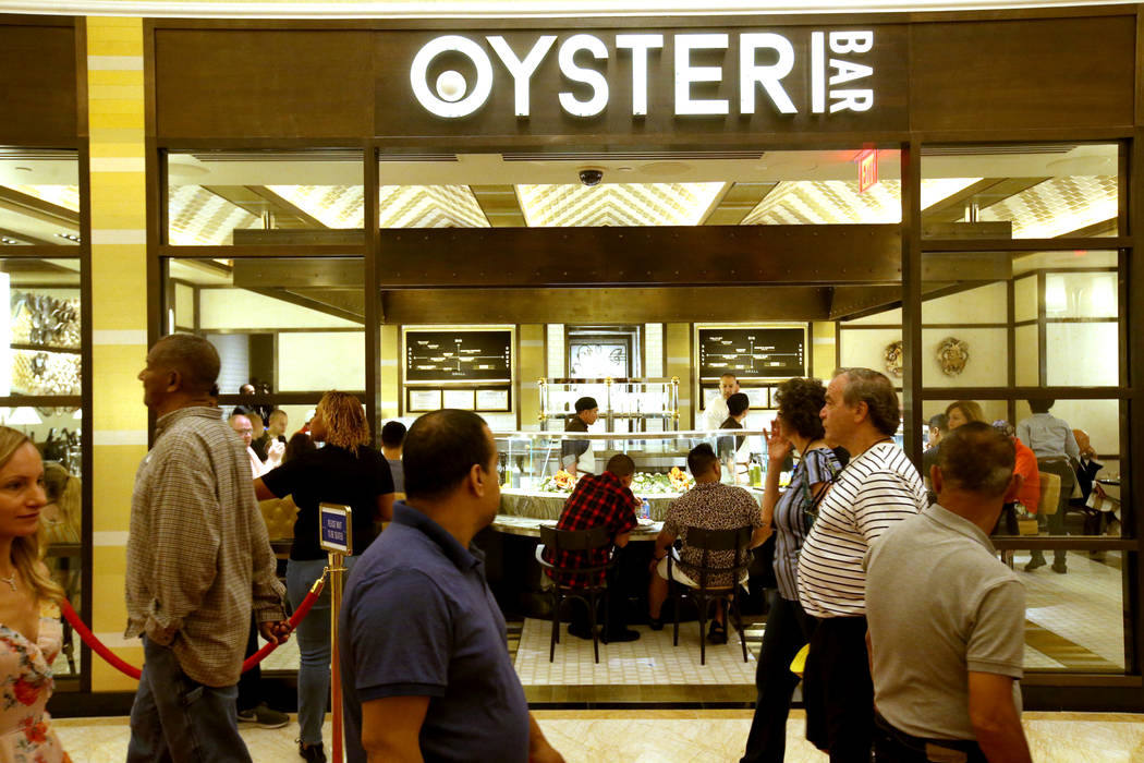 Guests walk past the Oyster Bar on opening day of the $2.6 billion Encore Boston Harbor in Ever ...