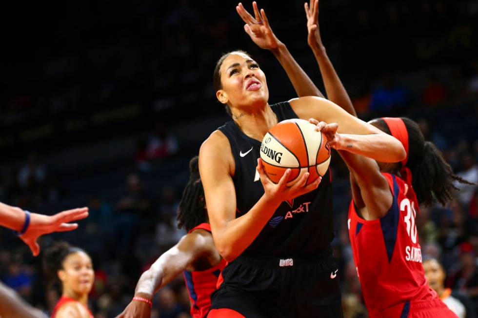 Las Vegas Aces center Liz Cambage (8) drives past Washington Mystics forward LaToya Sanders (30 ...