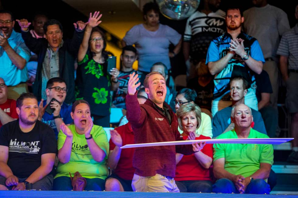 Brant Houghton with the USBC gives away tournament placards to the loudest fans during the U.S. ...
