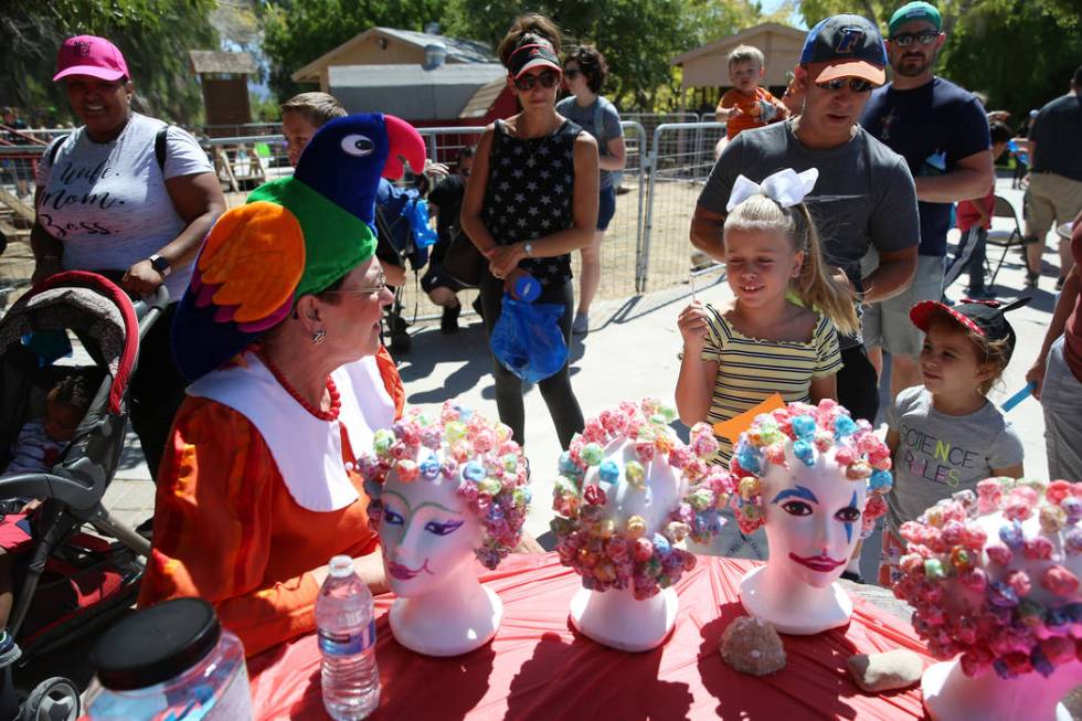 Volunteer Carol Bell, from left, talks to Gianna Bertuccini, 7, and her cousin Anna Rosenberg w ...