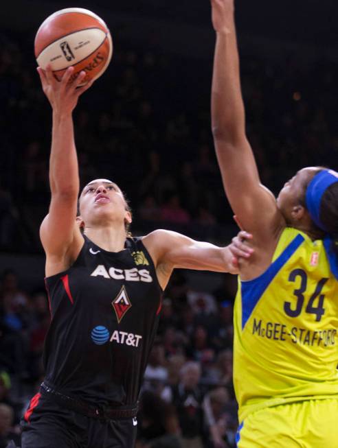 Las Vegas Aces forward Dearica Hamby (5) slices to the rim past Dallas Wings center Imani McGee ...