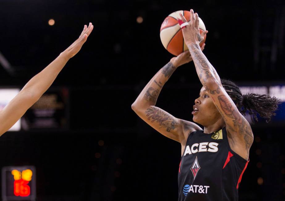 Las Vegas Aces forward Tamera Young (1) shoots a corner three point shot over a Dallas Wings de ...