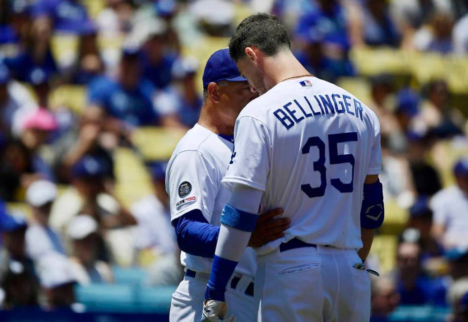 Los Angeles Dodgers manager Dave Roberts, left, talks with Cody Bellinger after Bellinger hit a ...