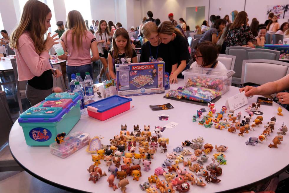 Attendees trade Littlest Pet Shop dolls during LPSCon West Coast at MEET Las Vegas, Sunday, Jun ...