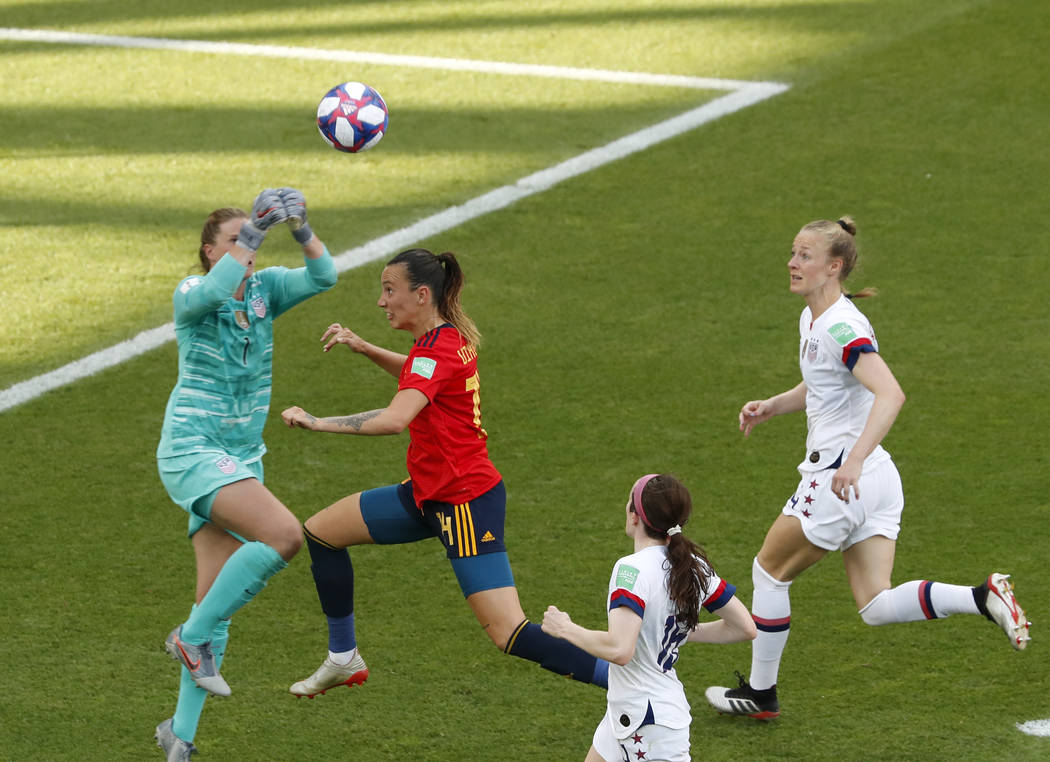 United States goalkeeper Alyssa Naeher, left, makes a save in front of Spain's Virginia Torreci ...