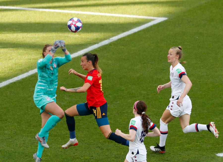 United States goalkeeper Alyssa Naeher, left, makes a save in front of Spain's Virginia Torreci ...