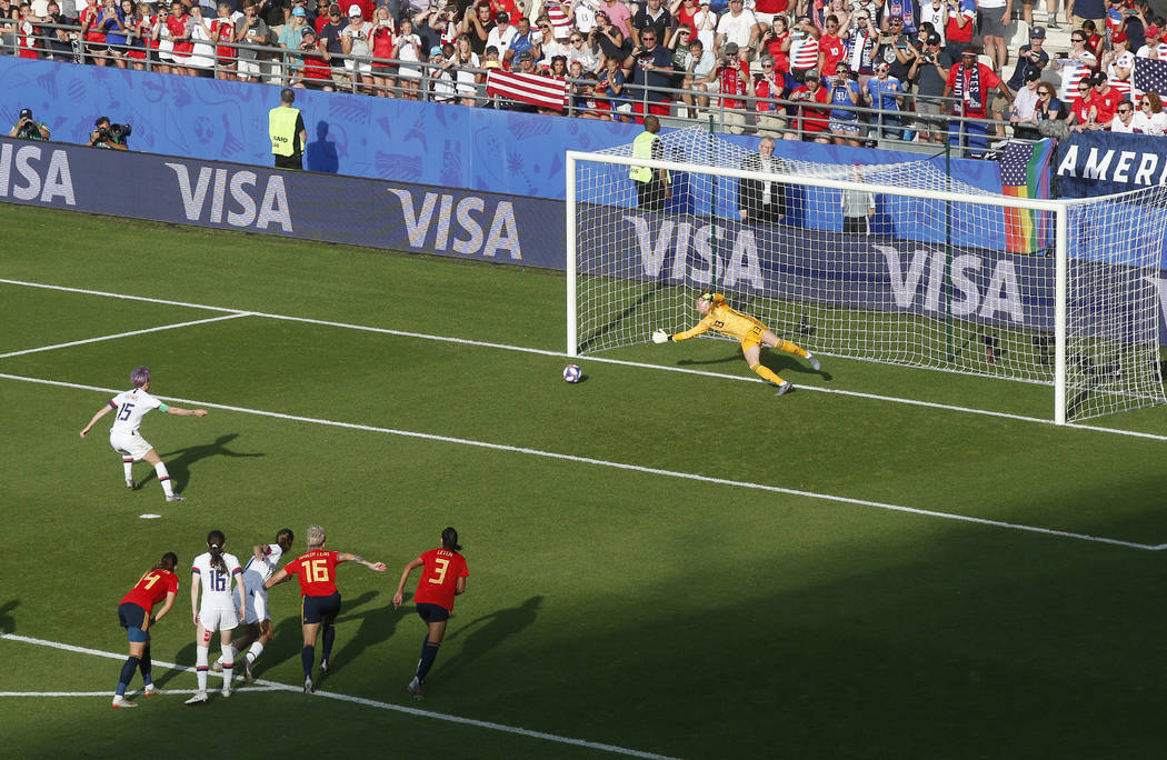 United States' Megan Rapinoe, left, scores her side's second goal from the penalty spot during ...