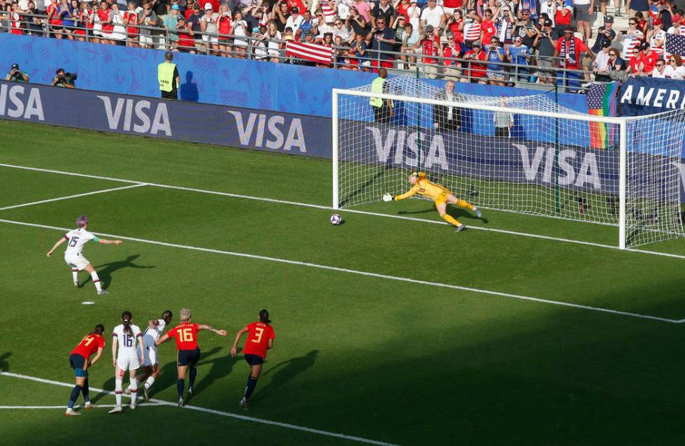 United States' Megan Rapinoe, left, scores her side's second goal from the penalty spot during ...