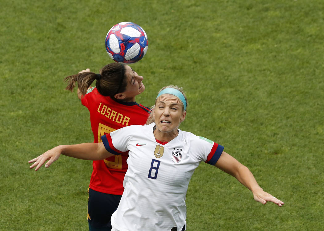 United States' Julie Ertz, right, jumps for the ball with Spain's Vicky Losada during the Women ...