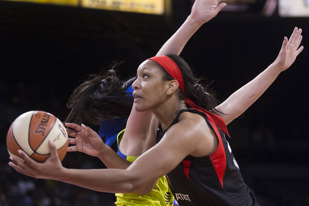 Las Vegas Aces center A'ja Wilson (22) slices to the rim past Dallas Wings forward Megan Gustaf ...