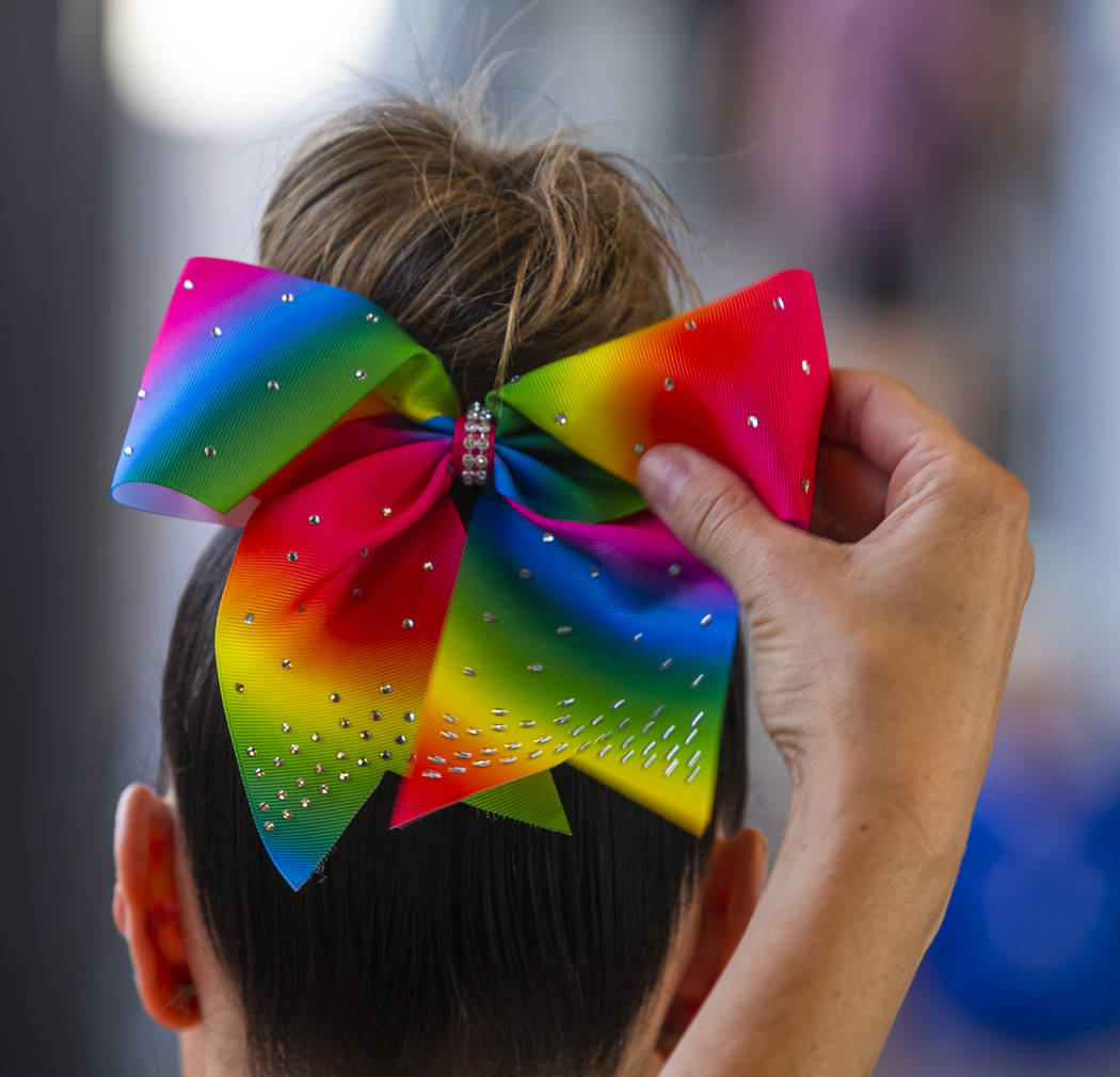 An Aviators fan has her rainbow bow adjusted during Pride Night at the Las Vegas Ballpark on Mo ...